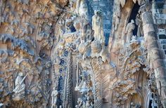 an intricately carved stone wall with sculptures on it