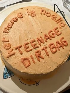 there is a large cake on the plate that says, home is cool and teenage dirtbag