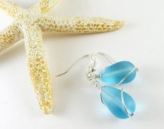 These light blue sea glass earrings are made with high-quality frosted glass that resembles ocean tumbled sea glass, but is much cheaper than ocean tumbled glass. Sea glass style jewelry is consistent in color, size, and shape, so the sea glass earrings you order will look just like the pair in the photos. I make these blue beach glass earrings in either silver plated or sterling silver materials. You can select the material you prefer from the drop-down menu. You can also select the ear wires y Turquoise Wire Wrapped Sea Glass Jewelry, Turquoise Sea Glass Wire Wrapped Jewelry, Elegant Blue Sea Glass Jewelry, Sea Glass Dangle Earrings Jewelry Set, Sea Glass Dangle Earrings With Matching Set, Handmade Sea Glass Drop Earrings, Sea Glass Dangle Earrings With Ear Wire, Teardrop Sea Glass For Jewelry Making, Minimalist Nickel Free Sea Glass Jewelry