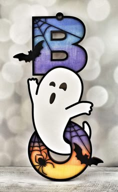 the letter b is decorated with a ghost and bats