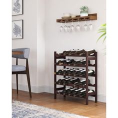 a wine rack with several bottles and glasses on it in front of a white wall