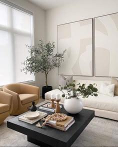 a living room with two couches and a coffee table in front of large windows