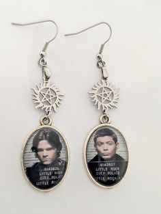 two earrings with pictures of the same person on them