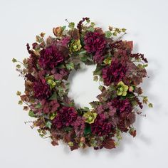 a wreath with purple flowers and green leaves on a white background for an autumn decoration