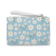 Introducing the Sky Blue Daisy Clutch Bag, a sweet and charming accessory perfect for adding a touch of calm to any outfit. The light blue color and delicate daisy print exude an adorable and pretty vibe, while the addition of white flowers adds a floral touch. Carry this bag to elevate any look with its calming and cute design. Designed with a loop handle to quickly free your hands, this fabulous clutch bag is made for anyone on the go. It can hold everyday essentials such as a phone, wallet, and keys. Carry your lipstick or makeup in here too! It features a zip fastening and a fully lined internal pocket. It is made of vegan leather in the Saffiano pattern finish that was invented by Prada. .: Material: 100% PU faux leather .: One size: 9.5" x 6.6" (24 x 17 cm).: Wrist strap.: Saffiano p Cute Blue Bag For Spring, Cute Blue Spring Bag, Cute Light Blue Bag For Gift, Bottle Garden, Blue Daisy, Daisy Print, Dress Jewelry, Light Blue Color, Phone Wallet