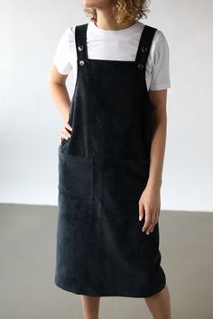 Pinafore dress in a velvet black fabric.   - Handmade in our studio from 96% cotton 4% spandex - Pinafore style - Attachable braces  - Front square pockets - Straight - cut body - Slit on the back side Black Dungaree Dress, Black Pinafore Dress, Black Dungaree, Cord Pinafore Dress, Black Dungarees, Black Pinafore, Corduroy Pinafore Dress, Upcycle Clothes Diy, Dungaree Dress