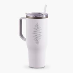 a white travel mug with a silver lid and a leaf design on the side, sitting against a white background