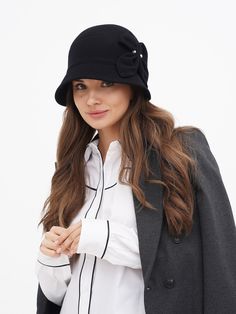 Discover the timeless elegance of our Women's Winter Cloche Hat, a perfect blend of classic style and modern comfort. Inspired by the iconic flapper era, this wool hat is a nod to the glamorous Gatsby days, bringing a touch of vintage charm to your wardrobe. Available in two sophisticated colors - classic black and a deep, dark blue - this hat is designed to complement any outfit, whether you're dressing up for a special occasion or adding a stylish accent to your everyday wear. Crafted with the highest quality wool, our cloche hat promises not only style but also warmth and comfort during the colder months. The wool fabric is carefully selected for its softness and durability, ensuring that the hat maintains its shape and elegance over time. The snug fit of the cloche design is both pract Luxury Wool Brimmed Cloche Hat, Luxury Brimmed Wool Cloche Hat, Luxury Flat Brim Cloche Hat For Winter, Luxury Wool Classic Cloche Hat, Luxury Chic Brimmed Cloche Hat, Elegant Luxury Cloche Felt Hat, Luxury Fitted Cloche Hat With Flat Brim, Luxury Elegant Cloche Fedora, Luxury Fitted Wide Brim Cloche Hat