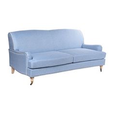 a blue couch sitting on top of a white floor