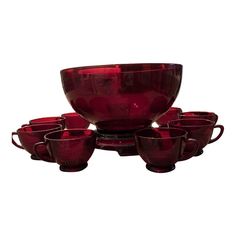 a set of red glass bowls and cups