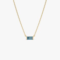 Discover our 14K Gold Baguette Cut London Blue Topaz Birthstone Necklace, showcasing a 0.45 ctw stone in a refined design. This dainty pendant is perfect for layering, highlighting the December birthstone with elegance. Ideal as a birthday gift, it seamlessly blends timeless charm with modern style. Crafted with precision, this necklace is a sophisticated addition to any jewelry collection. * Gold Kt: 14K Solid Gold * Available Gold Color: Yellow Gold * Length & Width: 7 x 3 MM * baguette London Blue Topaz: 1 pc 6x3 MM * Total CTW: 0.45 Ctw  * Ready to Ship in 1-2 Business Days ▶ See more of our Gemstone Jewelry - https://etsy.me/3CGRdMI ▶ See our storefront here - http://etsy.me/2lUcVnH  ▶ All store sections here * Diamond Rings - http://etsy.me/2lwKUl8 * Diamond Earrings - http://etsy.me Agate Wedding Ring, Topaz Birthstone, Gold Armband, Aquamarine Necklace, Dainty Pendant, Birthstone Pendant, Ruby Jewelry, Emerald Jewelry, Sapphire Jewelry