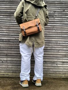 The material I used to make this bag is tabacco oiled leather, combined with dark brown vegetable tanned leather Fold to close musette ,closes with buckle and strap, and quick acces on the backside with pouch buttons There is a large exterior pocket on the backside, This bag is not lined and comes with a vegetable tanned leather strap adjustable and detachable This bag measures approximately 32 cm wide 24 cm tall  and 6 cm deep in inches this is 12.60  inch wide, 9.45 inch tall and 2.36 inch dee Leather Chest Bag With Anti-theft Pocket For Everyday Use, Musette Bag, Travel Leather Chest Bag With Anti-theft Pocket, Outdoor Leather Shoulder Bag With Anti-theft Pocket, Outdoor Military Satchel Bag, Messenger Bags, Style Expert, Vegetable Tanned Leather, Belgium