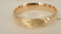 This is an 18k yellow gold bangle bracelet.  This inside of this bangle is 6.75 inches in circumference and is it 14mm wide.  You will not be disappointed with this purchase. **The dark spots that can be seen in some of the pictures are not on the item.  It is caused by the reflection of the camera used to take the photos.**All metal is tested with a Thermo Scientific Niton DXL precision metal Analyzer.*****    JACOBS JEWELERS 2119 MAIN ST DUNEDIN, FL 34698 STORE HOURS MON- SAT 10AM-6PM Guaranteed to be 100% authentic. DO NOT MISS OUT ON THIS BEAUTIFUL BRACELET.  IT IS IN EXCELLENT CONDITION.  WE ALSO SELL OTHER HIGH END JEWELRY.  SO PLEASE LET US KNOW WHAT YOU ARE LOOKING FOR.  IF YOU HAVE ANY QUESTIONS OR WOULD LIKE TO SCHEDULE AN APPOINTMENT PLEASE CONTACT US.  THANK YOU. PAYMENT INFORM High End Jewelry, Yellow Gold Bangle, The Reflection, Gold Bangle Bracelet, Fine Jewelry Bracelets, Gold Bangle, Store Hours, Bracelets And Charms, Gold Bangles