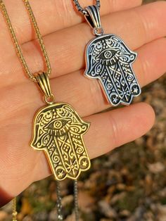 "Beautifully Hand crafted Hamsa pendants **IF YOU WANT A PENDANT ONLY AND NO CHAIN, PLEASE SELECT \"0\" CHAIN LENGTH** Solid 925 sterling silver! Unique custom made one of a kind! We have 2 styles! Rhodium finished & 14k yellow gold finished! Gold is vermeil bonded to solid silver underneath so color wont fade or tarnish Both are oxidized (blackened to give a more vintage look) Pendant measures roughly 1.25\" by 1.25\" (1.75\" w. bale)...weighs roughly 10.5 grams! 100% 925 silver...not plate Spiritual White Gold Jewelry Tarnish Resistant, Tarnish Resistant Silver Stainless Steel Jewelry, Silver Charms Jewelry In Brass, Symbolic Pendant Jewelry, Tarnish Resistant, Stainless Steel Amulet Pendant Jewelry, Silver Brass Charms Jewelry, Silver Brass Jewelry With Charms, Symbolic Pendant Jewelry Tarnish Resistant, Nickel Free 14k Gold Jewelry For Gifts