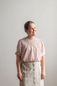 Effortless and classic, the Allison is a closet staple that easily can be dressed up or down! This top features a button closure in the back, dainty elastic cuffs, and a ruffle-cuff neckline. Try the Allison with a structured denim skirt and mules or a flowing knit skirt and flats. Fit: style is slightly breezy Style: socked bodice, elastic cuffs, short sleeved blouse with back button closure Color: strawberry pink Fabric content:100% polyester Care instructions: wash gentle cycle, cold; lay flat to dry, cool iron if needed. For best results, always follow care instructions on garment label. Our sizing is always approximate and can vary due to personal preference and style. For the best experience - and to make life easier for everyone! - please carefully measure yourself before placing yo Breezy Style, Short Sleeved Blouse, Be Intentional, Strawberry Pink, Smocked Top, Garment Labels, Make Life Easier, Modest Clothing, Curated Gifts