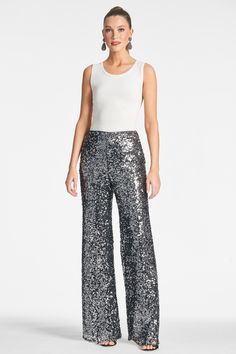 How can you say no to a shimmering and chic sequin trouser? Before you think that you can only dress these up, remember fashion is a feeling and if you want to wear these with a sweatshirt you can! This pant is the party, they upgrade every look and they are absolutely timeless. Plus, there is hidden stretch elastic at the back, so they are comfortable too!Details:Model is 5'10.5" wearing size 232" InseamSide ZipperScatter Sequins95% Polyester - 5% Spandex ImportedStyle #F233P05-021 Glamorous Embellished Bottoms For Evening, Glamorous Embellished Evening Pants, Embellished Bottoms For Evening Parties, Chic Embellished Pants For Party Season, Metallic Bottoms With Contrast Sequin For Party Season, Embellished Evening Bottoms For Party Season, Embellished Bottoms For Evening Party Season, Embellished Bottoms For Evening And Party Season, Chic Embellished Party Bottoms