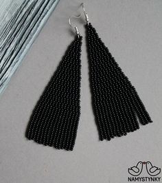 These black beaded earrings are made of high-quality Czech beads and strong synthetic thread. They are elegant, fashionable, and highly versatile, suitable for everyday wear. Features: Sterling silver components Color: white Length (approximate): 9 cm (3.5 in) This item is currently in stock. More beaded earrings http://etsy.me/2ycItdb Gerdan necklaces http://etsy.me/2mihf0J Beaded necklaces http://etsy.me/2Dkf1Fo Crochet necklaces http://etsy.me/2CAPdFc Back to shop https://www.etsy.com/shop/Na Black Beaded Earrings, Dark Earrings, Seed Bead Earring, Native Earrings, Beadwork Earrings, Bead Earring, Luxury Earrings, Necklace Beaded, Earrings Long