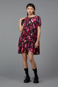 Embrace your inner diva with the Devil Dance Party Dress by Black Friday. This print dress features a round neckline and short sleeves, providing a classic silhouette that flatters all body types. The fitted style bodice accentuates the waist, while the flared skirt offers a fun and flirty vibe. The gathered waist adds volume to the skirt, enhancing the relaxed fit for ultimate comfort and style. Made from soft woven viscose, this dress is both lightweight and breathable, making it ideal for war Short Sleeve Printed Party Dress, Printed Short Sleeve Party Dress, Summer Party Dress With All Over Print, Short Sleeve Graphic Print Party Dress, Short Sleeve Graphic Print Dress For Party, Fitted Mini Dress With Graphic Print And Short Sleeves, Trendy Short Sleeve Mini Dress For Party, Summer Party Short Sleeve Dress With Cap Sleeves, Graphic Print Knee-length Party Dress