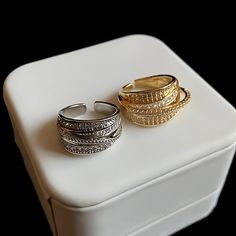 ✦ Indulge in the elegant allure of our Dainty Multi-Layer CZ Ring. This exquisite cocktail ring features multiple layers of sparkling CZ (Cubic Zirconia) stones, creating a captivating and glamorous look. Available in both gold and silver finishes, this ring offers versatility to suit your personal style. Its dainty design adds a touch of sophistication, making it perfect for special occasions or adding a touch of glamour to your everyday attire. Elevate your jewelry collection with our Dainty M Elegant Sparkling Cubic Zirconia Crystal Ring, Sparkling Open Diamond Ring, Elegant Crystal Open Ring With Rhinestones, Elegant Adjustable Sparkling Diamond Ring, Elegant Sparkling Adjustable Diamond Ring, Elegant Open Ring With Bling, Elegant Bling Open Ring, Elegant Adjustable Crystal Ring With Sparkling Stones, Elegant Gold Crystal Ring With Sparkling Detail