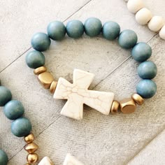 "This chunky cross bracelet is bound to become one of your favorites for any outfit! A natural cream howlite cross is accented with gold wood beads and your choice of 12mm waxed wooden beads. Bracelet is strung on sturdy stretch cord. Available in 7in, 7.5in and 8in lengths. Cross is approx 1.5in x 1.25in. Length can be customized. Please leave a note in the comments section with specific length needed. Note: For beads the same color as the cross, please choose the \"White\" color option. SHOP P Scripture Bracelets, Wooden Beads Bracelet, Stretch Beaded Bracelets Diy, Cross Bracelets, Blessing Beads, Printers Drawer, Homemade Bracelets, Clay Bracelets, Christian Bracelets