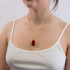 This faceted sterling silver Carnelian necklace will add a vibrant burst of red-orange color to your wardrobe. Wear Carnelian to increase vitality & personal willpower. Carnelian is known to banish sorrow and replace it with the energy of love. Wear Carnelian to awaken one's inherent talents, abilities, vitality, and personal willpower. Stone Origin: India Stone Measures Approximately: 27 x 20 mm Materials: Hand Crafted 925 Polished Sterling Silver with 14k Yellow Gold Vermeil Finish and Gold Fi Red Faceted Carnelian Jewelry, Red Faceted Pendant Necklaces, Red Faceted Pendant Necklace, Faceted Carnelian Jewelry Gift, Red Agate Gemstone Necklace, Red Carnelian Gemstone Necklace, Red Faceted Carnelian Necklaces, Red Oval Pendant Spiritual Necklace, Red Polished Pendant Necklaces