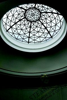 a circular glass window in the ceiling of a building