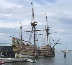 an old sailing ship is docked in the water