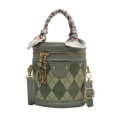 Introducing our Chic Geometric Quilted Handbag, a perfect blend of style and practicality for the modern woman on the go. This handbag features a unique geometric quilted design that adds a touch of sophistication and texture to the overall look. The soft sage green color is versatile and on-trend, ensuring that this bag will complement a wide range of outfits, from casual to formal.Attention to detail is evident in the design, with a decorative scarf tied around the handle, adding a playful and feminine touch. The bag is accented with gold-tone hardware, including a charm and zipper, which not only enhances its elegance but also offers durability. The compact size is ideal for carrying essentials without the bulk, making it a great choice for day-to-day use or special occasions.Functional Soft Sage Green, Quilted Handbag, Argyle Diamonds, Sage Green Color, Diamond Top, Chic Scarves, Quilted Handbags, Round Bag, Of Outfits