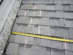 a measuring tape is on the roof of a house