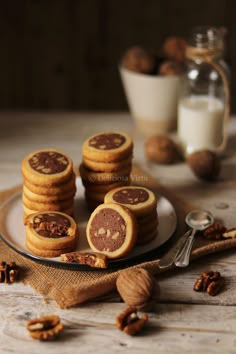 some cookies are on a plate with nuts