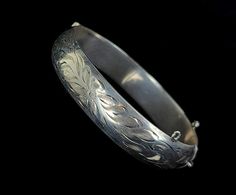 "Vintage Mid-Century Sterling Burkhardt Birks Canada Engraved Floral Thick Bangle Bracelet 7\" Item offered is an antique sterling engraved etched Burkhardt floral bangle bracelet. This bracelet consists of gorgeous etched floral designs. The clasp is a tab insert clasp. There is no safety chain attached. Condition is good, with age related wear. Inside is marked \"Sterling\" and \"B\". Please see photos provided as they are an extension of our written description. Measurements: Bracelet length: Engraved Bracelets For Weddings And Festivals, Engraved Bracelets For Wedding And Festivals, Wedding Etched Round Bangle, Engraved Cuff Bracelet For Wedding And Festivals, Etched Bangle Bracelets For Wedding, Festive Engraved Bangle Bracelet, Engraved Bangle Bracelet For Wedding, Formal Etched Bangle, Etched Bangle For Wedding