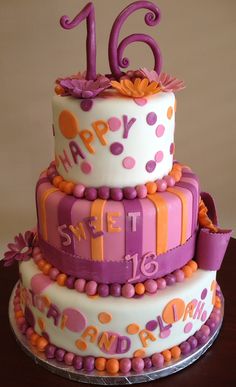 a birthday cake decorated with purple and orange decorations