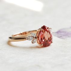 teardrop Padparadscha pink sapphire ring on finger Luxury Elegant Pink Sapphire Ring, Pink Saffire Ring, Yellow Gold Pink Sapphire Ring, Padparadscha Sapphire Engagement Ring, Pink Saphire Engament Ring, Sapphire Ring Simple, Padparadscha Sapphire Ring, Wedding Rings Pink Sapphire, Glowing Heart