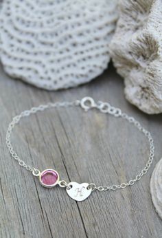 This listing is for one bracelet, made especially for a little girl! Personalized sterling silver chain bracelet with one sweet initial heart tag and one Swarovski Birthstone charm. Please select initial and birthstone (or favourite color!) from the drop-down menus and indicate the size you need. The length/size includes the heart tag and birthstone charm. Half an inch of extension chain is always added - for better fit and easy adjustment as the child grows. The bracelet size recommendations ar Sterling Silver Name Bracelet With Heart Charm For Gift, Personalized Silver Heart Bracelet For Mother's Day, Silver Name Bracelet With Heart Charm, Silver Name Bracelet With Heart Charm As Gift, Silver Name Bracelet With Heart Charm For Gift, Personalized Silver Name Bracelet With Heart Shape, Personalized Sterling Silver Bracelet With Heart Charm, Silver Heart-shaped Name Bracelet For Personalized Gift, Personalized Pink Sterling Silver Jewelry