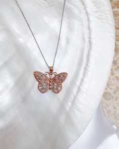 Give her the gift of wings with this beautiful butterfly necklace.DETAILS- 14k rose gold butterfly with rhodium plating- Chain option is 14k gold- Chain style may vary slightly- Approximately 1 inch wide x 3/4 inch tall (including bail)VARIATIONSIf you require any variation of this style (a different style chain, longer chain, etc.) feel free to message us. We will do our best to accommodate you. Additional costs may apply depending on the variation.POLICYWe do accept returns on this item minus Fine Jewelry Rose Gold Butterfly Charm, Elegant Rose Gold Jewelry With Butterfly Clasp, Rose Gold Butterfly Fine Jewelry, Rose Gold Sterling Silver Butterfly Necklace, Elegant Rose Gold Jewelry With Butterfly Charm, Rose Gold Sterling Silver Butterfly Necklace Perfect For Gifts, Rose Gold Sterling Silver Butterfly Necklace Gift, Butterfly Shaped Rose Gold Jewelry For Gifts, Rose Gold Butterfly Jewelry For Gifts