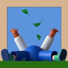 a person laying on the ground with their hands in the air and flying green leaves