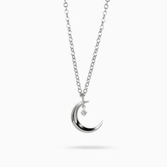 The Astria Luna Charm Pendant features a crescent moon with beveled edges. A small, white diamond charm dangles from the moon in the shape of a star. The Astria collection is dedicated to the strength we draw from the greater cosmos. Recycled metals White diamond Approximately .01 total carat weight Handcrafted and made-to-order Because every piece in our collection is made-to-order, designs can be modified by request. We can customize just about anything for you, from preferred stone, to shape, Celestial White Gold Jewelry With Single Diamond, Sterling Silver Crescent Necklace With Charms, White Crescent Diamond Jewelry, Moon Shaped Sterling Silver Jewelry With Diamond Accents, Elegant Moon Shaped Necklace With Star Charm, Elegant Moon-shaped Necklace With Star Charm, Elegant Moon Shaped Jewelry With Charms, Elegant Moon-shaped Charms Jewelry, Elegant Moon-shaped Jewelry With Charms