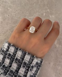 a woman's hand with a diamond ring on it