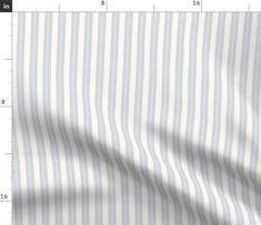 a white and blue striped shirting fabric with a ruler in front of the image