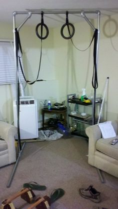 a living room filled with furniture and clutter on top of carpeted flooring