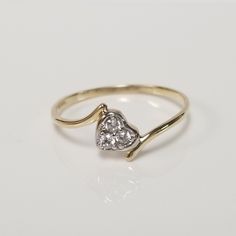 "Thanks for shopping our vintage estate store. We tend to sell well below wholesale and truly hope you enjoy all of our items. Many of the items are one of a kind, so please enjoy scrolling through the pictures and hopefully something will catch your eye. Black spots are from camera or reflections. Estate 10k yellow gold heart cz .05ct diamond ring. Ring size: 7.5 Setting: 4mm 1/4\" Band width: 1.5mm Weight: .86 gram Nice petite ring without the high cost. Marked 10k." Hallmarked Heart-shaped Diamond Ring For Anniversary, Diamond Heart Cut Ring Hallmarked, Heart-shaped Hallmarked Diamond Ring, Antique Heart Shaped Rings For Anniversary, Antique Heart-shaped Rings For Anniversary, 14k Stamped Heart Cut Diamond Ring For Anniversary, Heart Cut Diamond Ring Stamped 14k For Anniversary, Heirloom Heart-shaped Diamond Ring For Anniversary, Heart Cut Diamond Ring For Anniversary, Stamped 14k