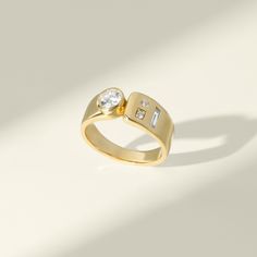 a gold ring with two diamonds on it