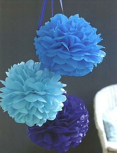 three blue and purple paper flowers in a vase