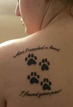 a woman with a tattoo on her back that says, when i needed a name, i found your paw