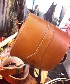 This is a Leather Handmade Cross-body Bag in 4 colors, Natural Tan, Black, Vintage Brown and Brown. It has two inner compartments and secures with a metallic clasp. The strap is adjustable for your shoulder. Width: 6.3 inches (16 cm) Height: 6.3 inches (16 cm) Depth: 1.8 inches (4.5 cm) Natural vegetable tanned leather will age and darken with the sun just like your own skin. Sun exposure and daily handling will give natural vegetable tanned leather a rustic look over time. TOP QUALITY - The Lea Brown Saddle Bag With Detachable Strap, Cognac Saddle Bag With Removable Pouch, Vintage Saddle Bag With Adjustable Strap, Cognac Saddle Bag Satchel With Adjustable Strap, Cognac Saddle Bag With Leather Lining, Vintage Saddle Bag Tote With Removable Pouch, Brown Saddle Shoulder Bag, Saddle Bag With Detachable Strap For Daily Use, Daily Use Saddle Bag With Adjustable Strap