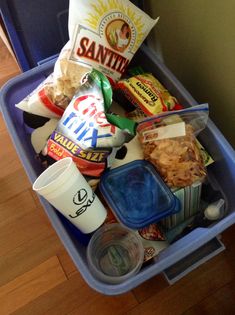 a blue trash can filled with food and drinks