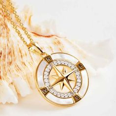 The 14k Gold Vermeil Mother of Pearl Compass Necklace is a stylish and sturdy piece of jewelry. The compass houses a stunning mother of pearl within the chapter ring with a dazzling array of white cubic zirconias at the heart of the compass. Additionally, the brilliant star-shaped arrow in the center of the compass depicts the different zones of the world. The necklace is cast using high-quality 925 sterling silver with a thick layer of 14K gold. In addition, the sparkling CZ’s and the Mother of White Gold Jewelry With Compass Design, Round Pendant Jewelry With Compass Design For Anniversary, Anniversary Yellow Gold Compass Jewelry, Anniversary Medallion Jewelry With Compass Design, Round Diamond Jewelry With Compass Design, Compass Design Round Pendant Jewelry For Anniversary, Round Pendant Compass Design Jewelry For Anniversary, Luxury Silver Jewelry With Compass Design, White Gold Pendant Jewelry With Compass Design