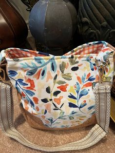 Gorgeous floral pattern bag.  Made with canvas exterior and fabric lining.  One of a kind.  Interior is orange checked canvas fabric.  Bag has two nice sized pockets on interior and one zippers pull pocket.  Four metal feet on bottom.  Magnetic snap closure on top.  Great quality, cork accents.  Can wear as a handbag or crossbody bag.  Will last for years to come.  Friends will go crazy over this handmade bag! Orange Satchel With Zipper For Everyday Use, Fabric Tote Shoulder Bag With Zipper, Fabric Tote Shoulder Bag With Zipper Closure, Multicolor Canvas Shoulder Bag With Zipper Closure, Casual Fabric Hobo Bag For Everyday, Orange Cotton Shoulder Bag For Travel, Orange Cotton Travel Shoulder Bag, Daily Use Fabric Shoulder Bag With Zipper Pocket, Fabric Shoulder Bag With Zipper Pocket For Daily Use