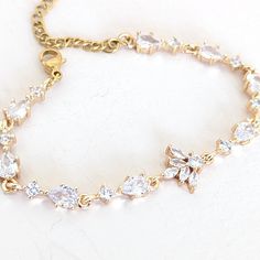 A single strand of diamonds will beautifully complement any wedding dress. Diamonds go with everything, just as lab diamonds go with every color.The CZ marquise will make a perfect finishing touch to your elegant look.DETAILS● Designed and handcrafted by ©JazzyAndGlitzy● This delicate drop and leaf-designed bridal bracelet feature AAA+A grade cubic zirconium.And the finish is with rhodium-plated silver or rose gold.● The bracelet measures 6 inches long + 2 inches extender chain.● Lead, nickel, a Dazzling Tennis Bracelet With Diamond Accents For Wedding, Classic Cubic Zirconia Crystal Bracelet For Wedding, Dazzling Tennis Bracelet With Sparkling Stones For Wedding, Classic Diamond Crystal Bracelet For Wedding, Wedding Tennis Bracelet With Diamond Accents, Classic Diamond White Crystal Bracelet For Wedding, Elegant Cubic Zirconia Crystal Bracelet With Diamond Cut, Elegant Cubic Zirconia Bracelet With Diamond Cut, Elegant Diamond Cut Cubic Zirconia Crystal Bracelet