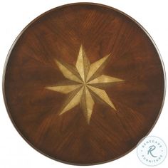 a wooden table with a star design on the top and gold foil inlays